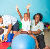 Social Worker and student at the Stimulation Plus facility in Kingston beaming with joy